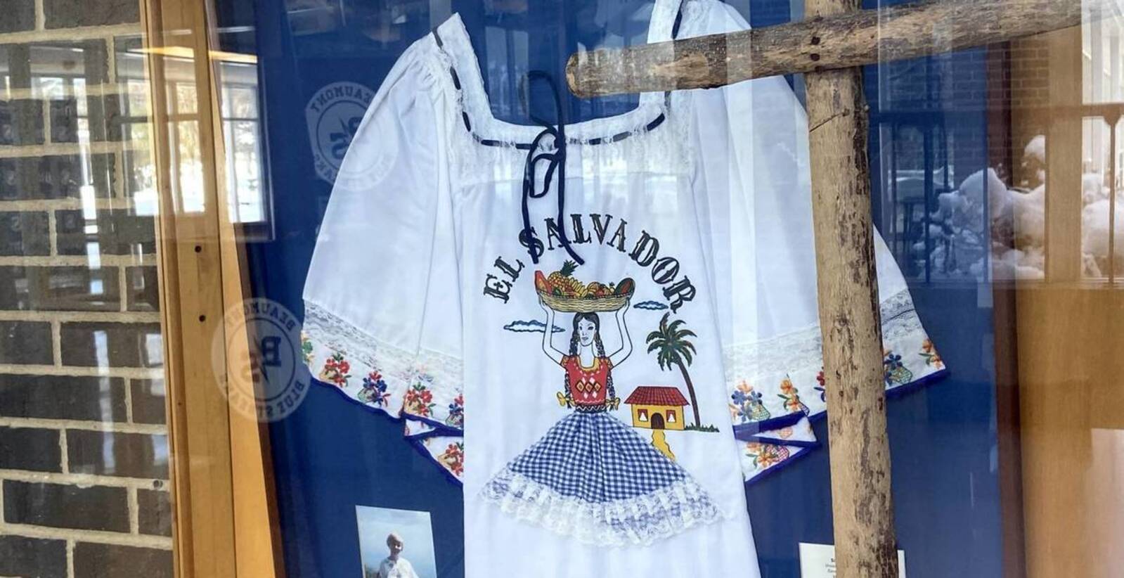 Dorothy'sSalvadoranblouse(framed),Largewoodencross,madebyCampesinos,markingthechurchwomen'sgraveinElSalvador.