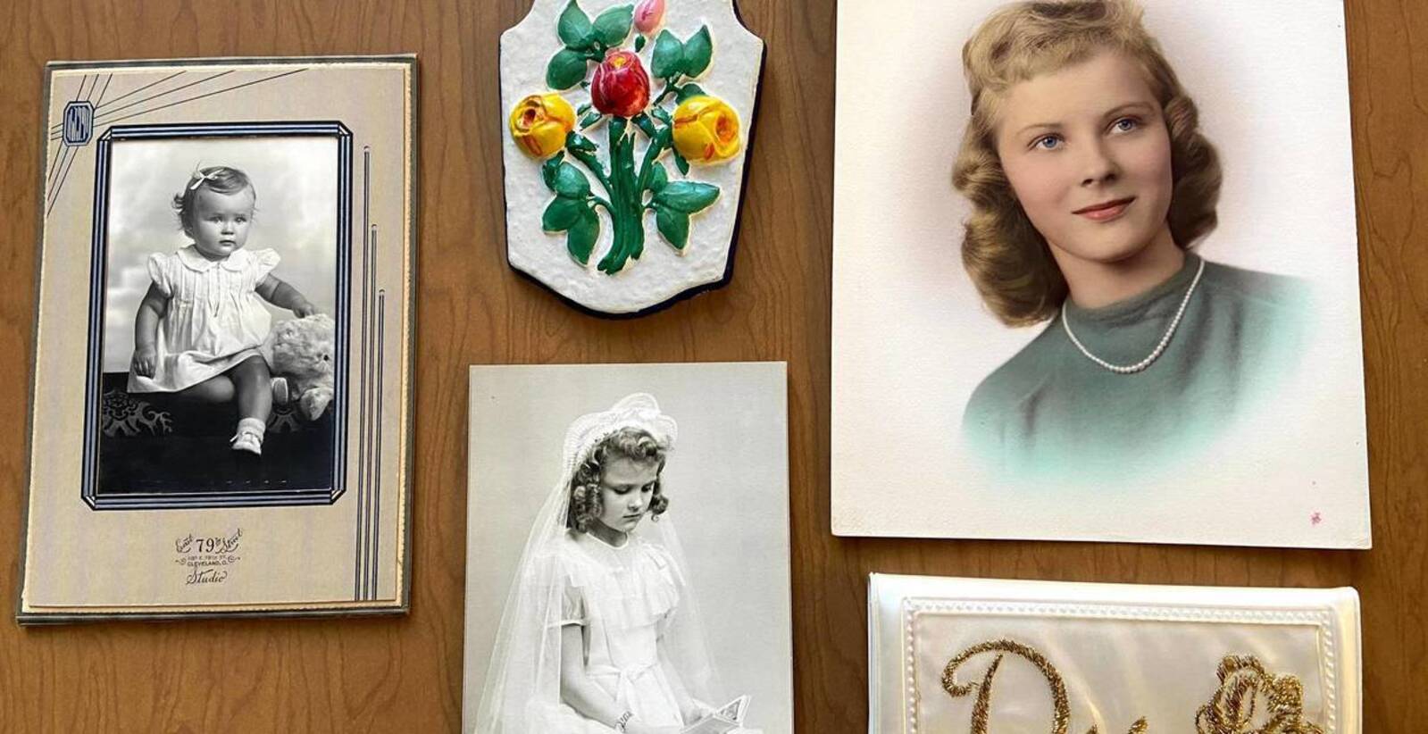 DorotheaLu,age1,PaintedplastersculptureDorothymadeasanelementaryschoolstudentatSt.GeorgeSchool,FirstCommunionPortrait,GraduationPortrait,Dorothy'swhitewalletonwhichisembroideredagoldD